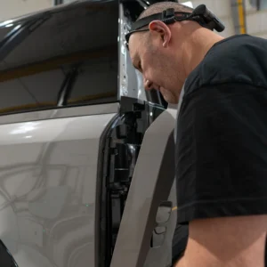 Rear light cluster cover being fitted to a Borasco Grey Apache Defender 90