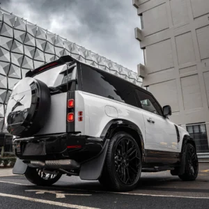 A Borasco Grey Apache Defender 90 parked by two grey buildings in Leeds City Centre